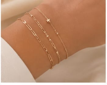 Layered gold bracelets with a star charm