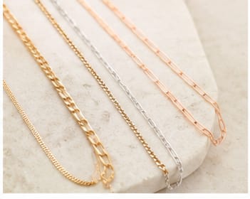 Necklace chains in three metals on marble