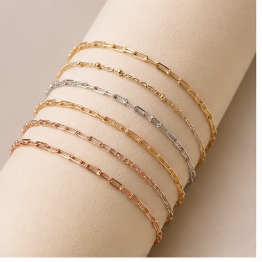 Gold, silver and rose gold chains on a fabric roll
